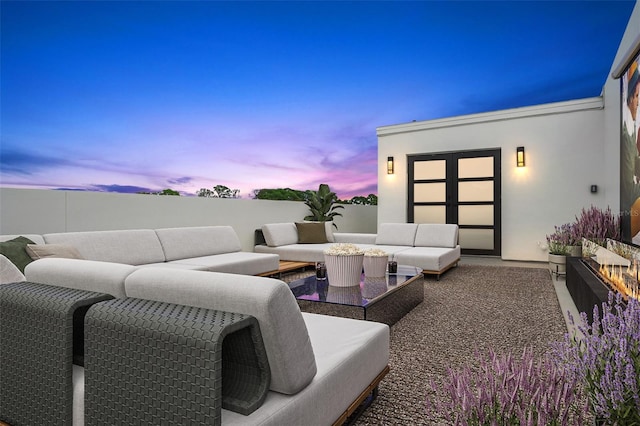 patio terrace at dusk featuring an outdoor hangout area