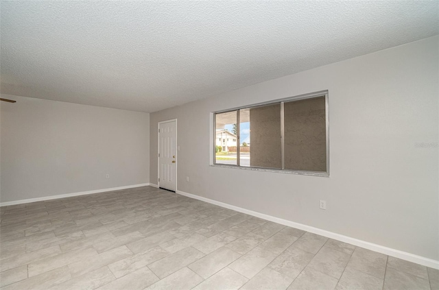 empty room with a textured ceiling