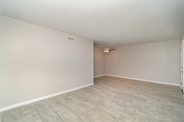 empty room featuring a textured ceiling and ceiling fan