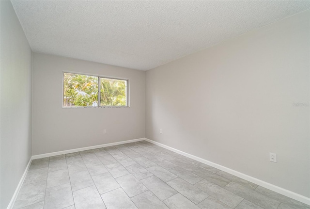 empty room featuring a textured ceiling