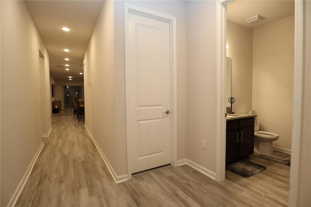 corridor with light wood-type flooring