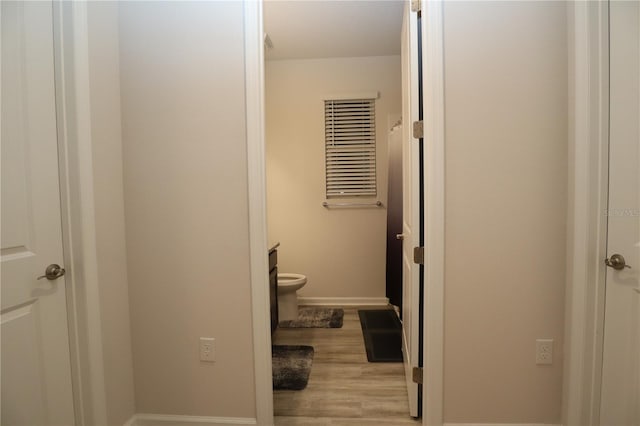 corridor with light hardwood / wood-style floors