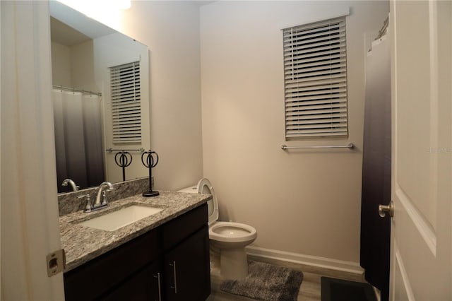 bathroom with vanity, toilet, hardwood / wood-style flooring, and a shower with curtain