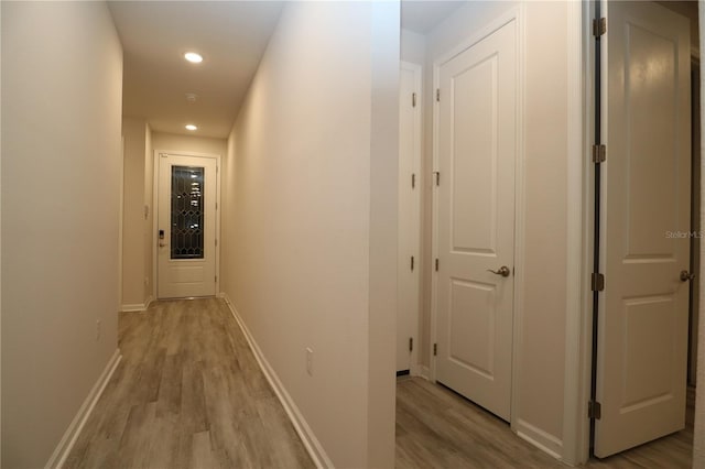 corridor with light hardwood / wood-style flooring