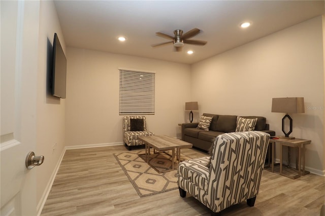 living room featuring light hardwood / wood-style floors and ceiling fan