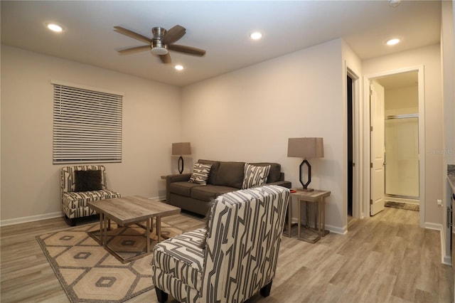 living room featuring light hardwood / wood-style flooring and ceiling fan