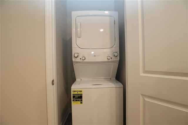 laundry room featuring stacked washer / drying machine