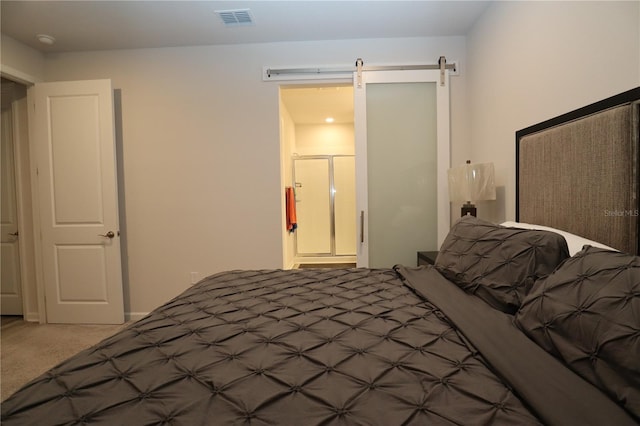 carpeted bedroom featuring a barn door