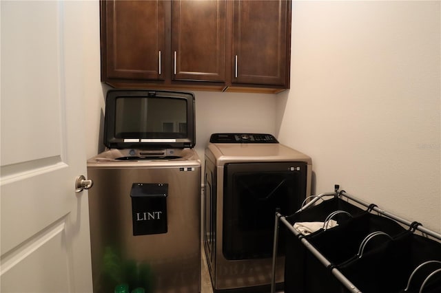 laundry room with cabinets and washing machine and dryer