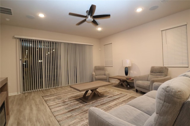 living room featuring light wood-type flooring and ceiling fan