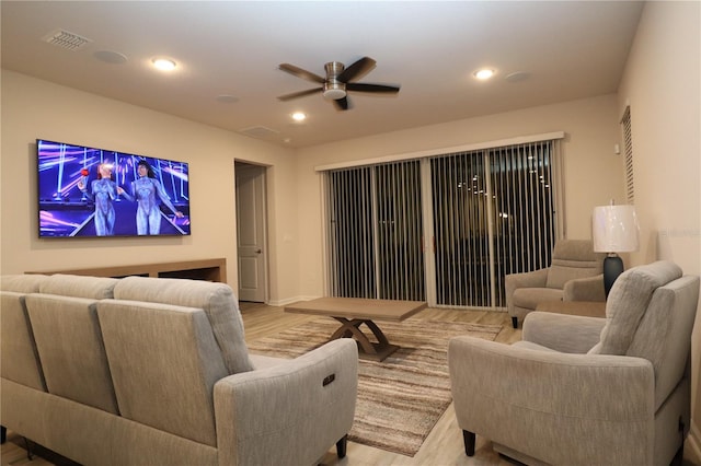 home theater with light hardwood / wood-style flooring and ceiling fan