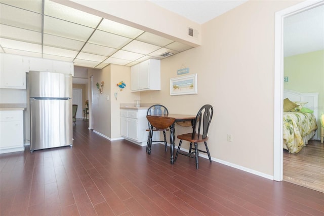 315 30th Ave W Unit B201, Bradenton, FL 34205 - dining space featuring dark wood-style flooring, baseboards, and a drop ceiling