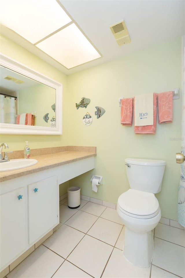 315 30th Ave W Unit B201, Bradenton, FL 34205 - bathroom with toilet, vanity, tile patterned floors, and baseboards