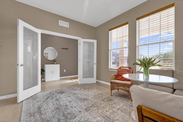 sitting room featuring french doors and light tile patterned floors