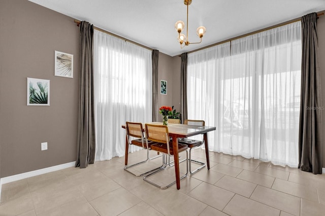 tiled dining room featuring a chandelier