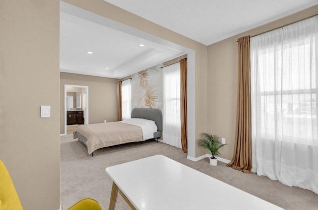 carpeted bedroom featuring ensuite bathroom