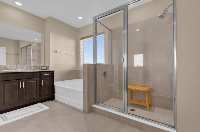 bathroom featuring vanity, independent shower and bath, and tile patterned floors