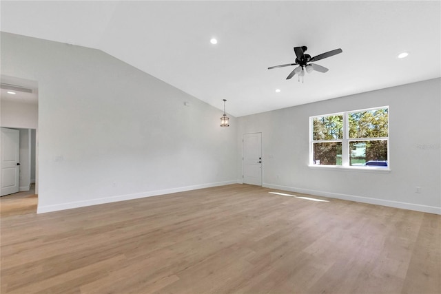 unfurnished room featuring light hardwood / wood-style floors, lofted ceiling, and ceiling fan