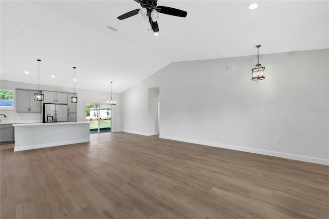 unfurnished living room with ceiling fan, hardwood / wood-style flooring, lofted ceiling, and a wealth of natural light