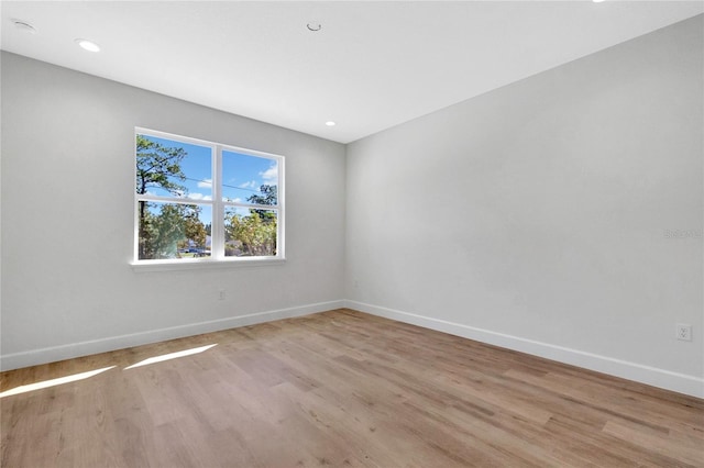 spare room with light wood-type flooring