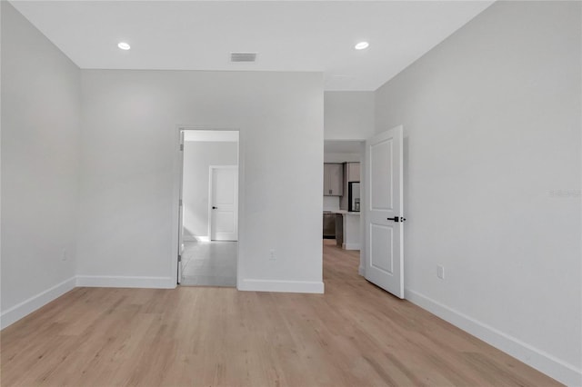 unfurnished room with light hardwood / wood-style flooring