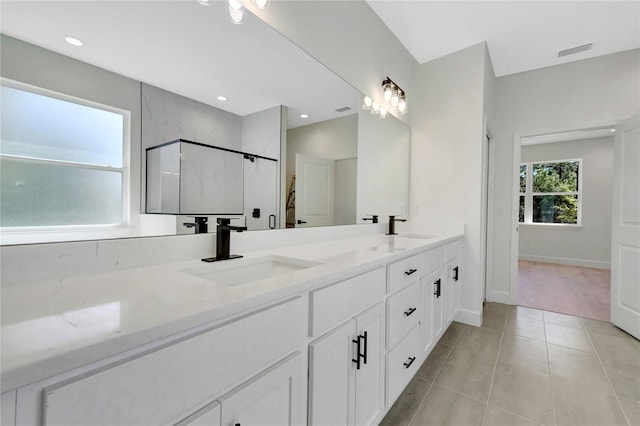 bathroom with vanity, tile patterned flooring, and an enclosed shower