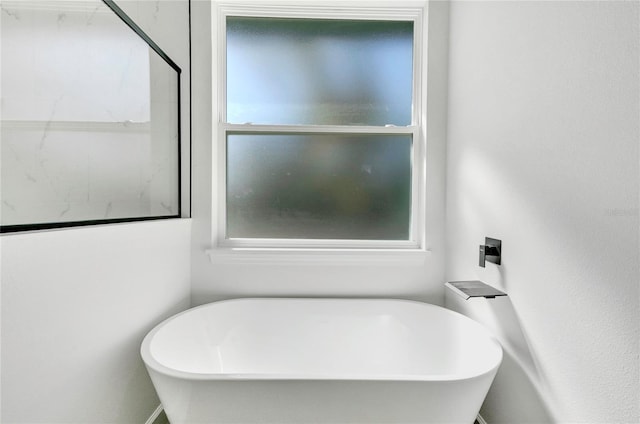 bathroom featuring a tub to relax in