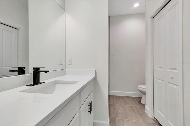 bathroom with vanity, toilet, and tile patterned flooring