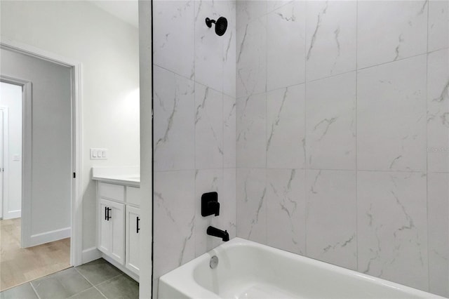 bathroom with vanity, tiled shower / bath combo, and wood-type flooring