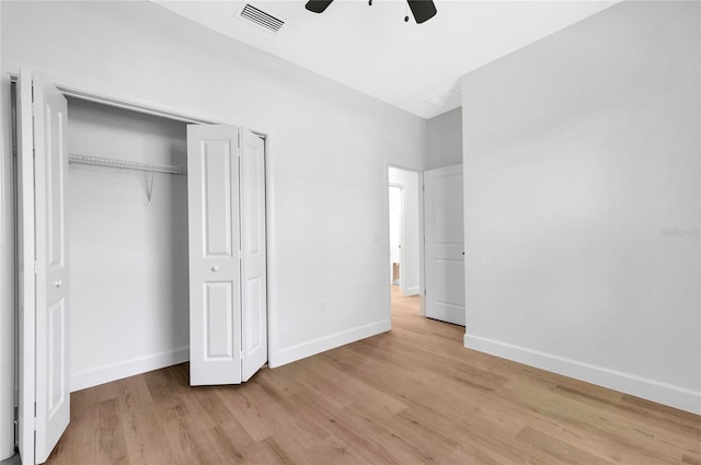 unfurnished bedroom with a closet, light wood-type flooring, and ceiling fan