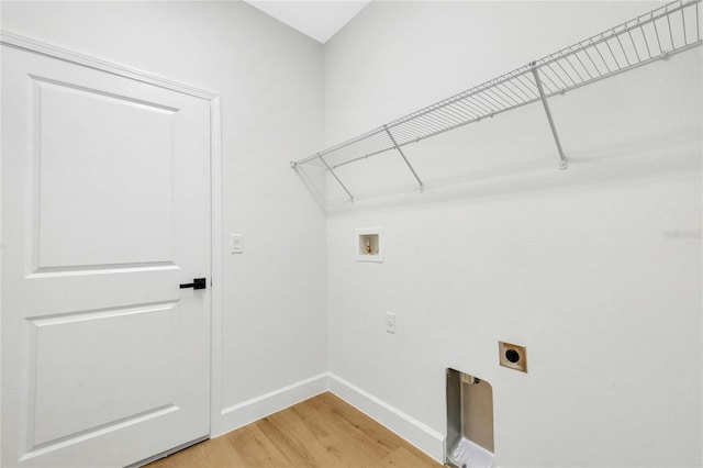 washroom with hookup for an electric dryer, hookup for a washing machine, and hardwood / wood-style flooring