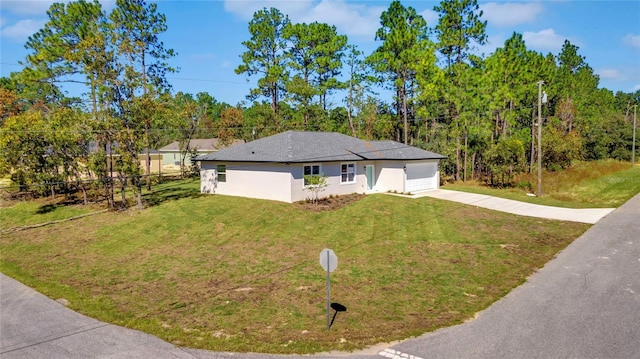 single story home with a front yard and a garage