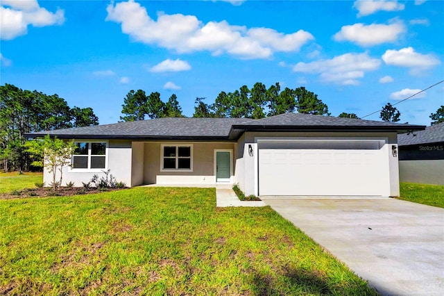 view of front of home with a front lawn and a garage