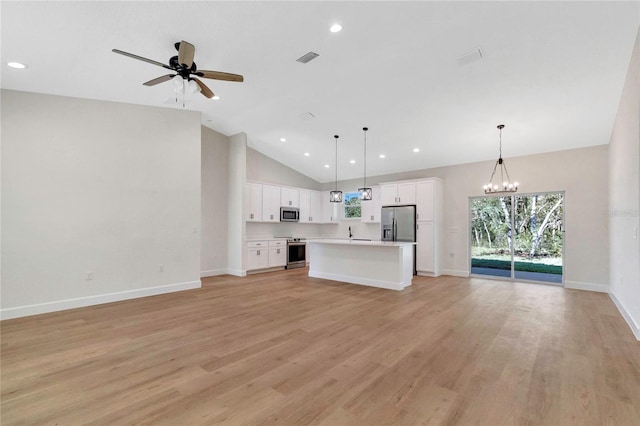 kitchen with white cabinets, a kitchen island, light hardwood / wood-style flooring, decorative light fixtures, and stainless steel appliances