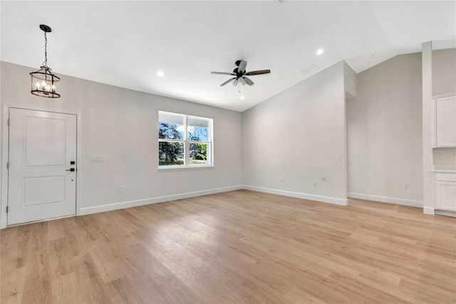 interior space with lofted ceiling, ceiling fan with notable chandelier, and light wood-type flooring