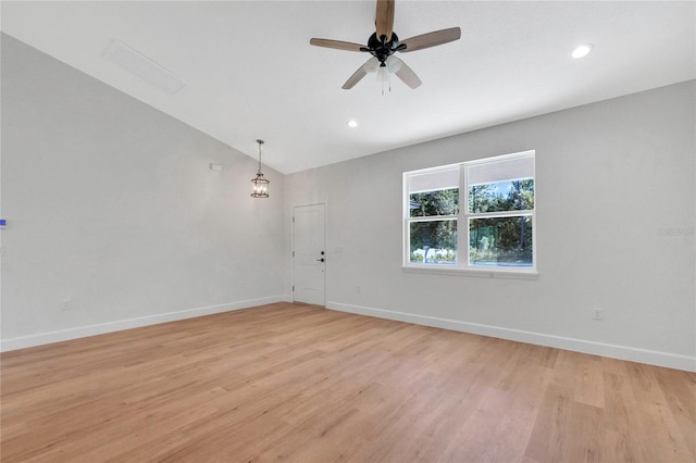 empty room featuring lofted ceiling, light hardwood / wood-style flooring, and ceiling fan