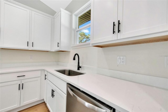 kitchen with white cabinetry, dishwasher, and sink