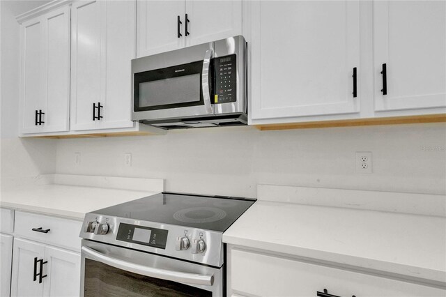 kitchen featuring appliances with stainless steel finishes and white cabinets