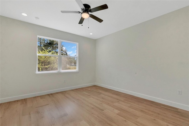 spare room featuring ceiling fan and light hardwood / wood-style flooring