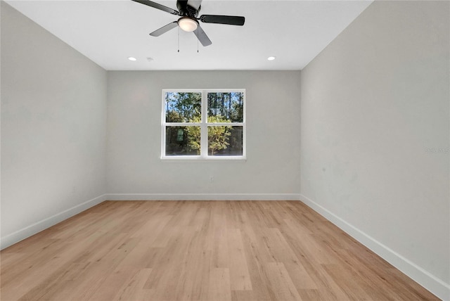 empty room with ceiling fan and light wood-type flooring