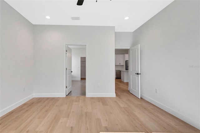 unfurnished bedroom with light hardwood / wood-style floors and ceiling fan