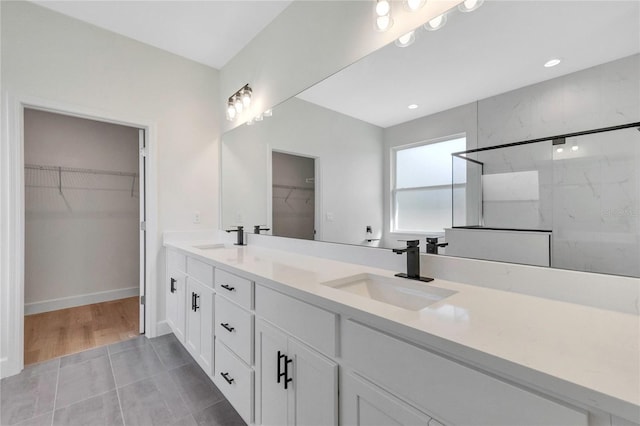 bathroom featuring vanity, tile patterned floors, and walk in shower