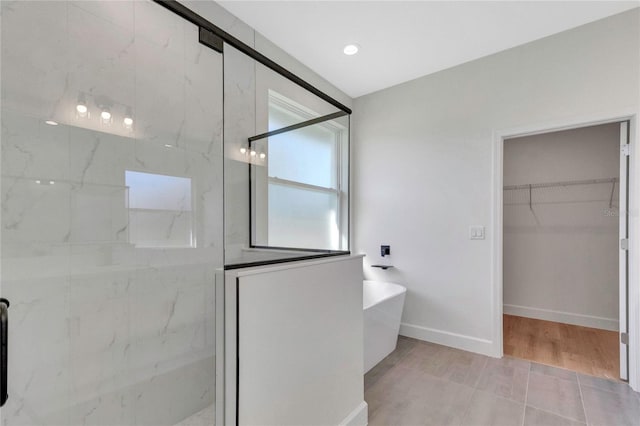 bathroom featuring tile patterned flooring and shower with separate bathtub