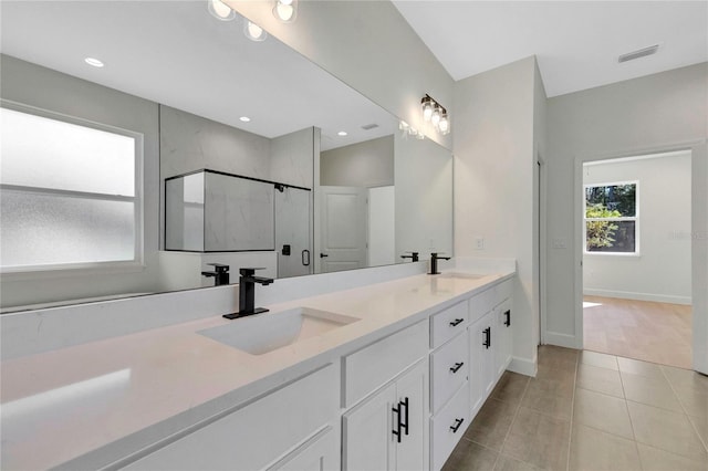 bathroom with vanity, a shower with shower door, and tile patterned flooring