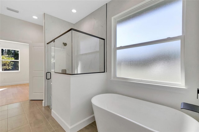 bathroom with tile patterned floors and plus walk in shower