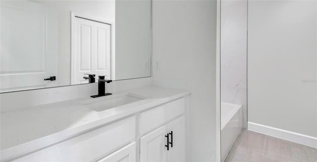 bathroom with vanity, a bathtub, and tile patterned floors