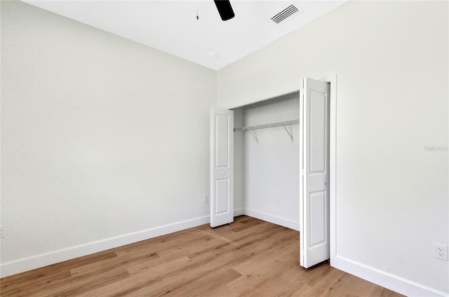 unfurnished bedroom featuring a closet, light hardwood / wood-style floors, and ceiling fan