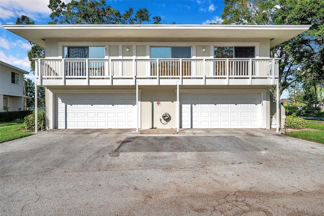 2937 Bough Ave Unit D, Clearwater, FL 33760 - view of front of house with a garage, driveway, and stucco siding