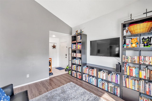 2937 Bough Ave Unit D, Clearwater, FL 33760 - sitting room featuring wood finished floors, vaulted ceiling, and baseboards