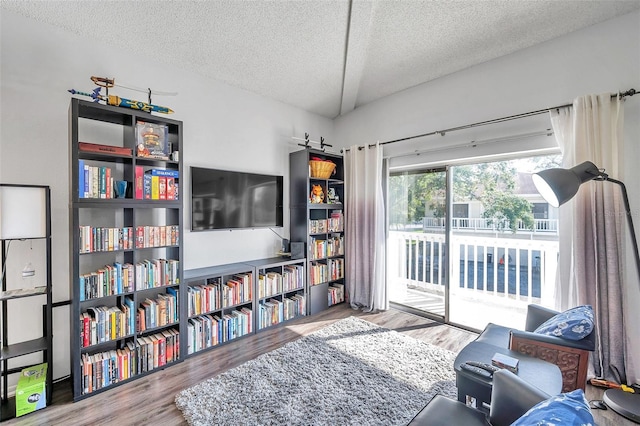 sitting room with hardwood / wood-style floors and a textured ceiling